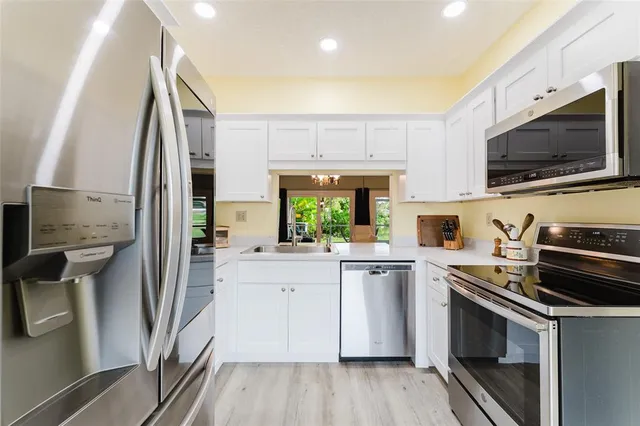 a kitchen with a sink stove and refrigerator