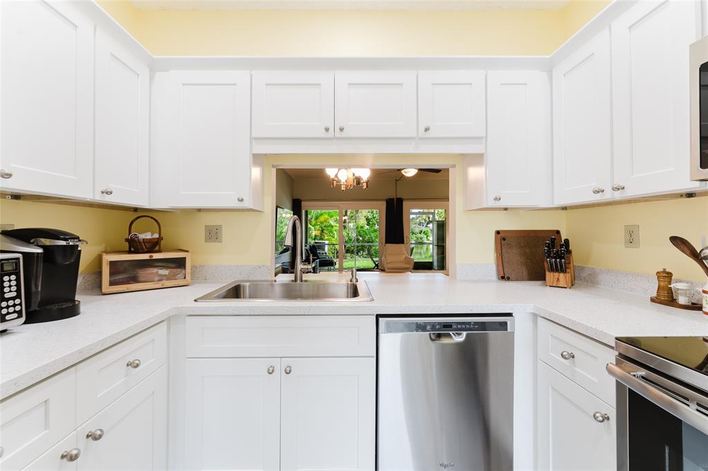 272 West Hemingway Circle Margate, FL 33063 - Photo 5 of 61 a kitchen with stainless steel appliances granite countertop a sink a stove and white cabinets