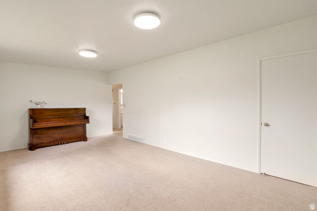 447 550 South Bountiful, UT 84010 - Photo 3 of 25 Carpeted interior space featuring white walls and two ceiling-mounted circular light fixtures