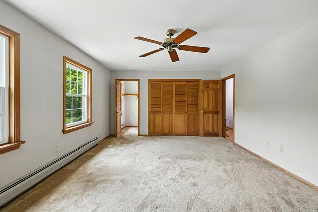a view of room with hardwood floor and ceiling fan
