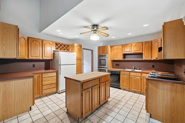 a kitchen with granite countertop appliances cabinets and furniture