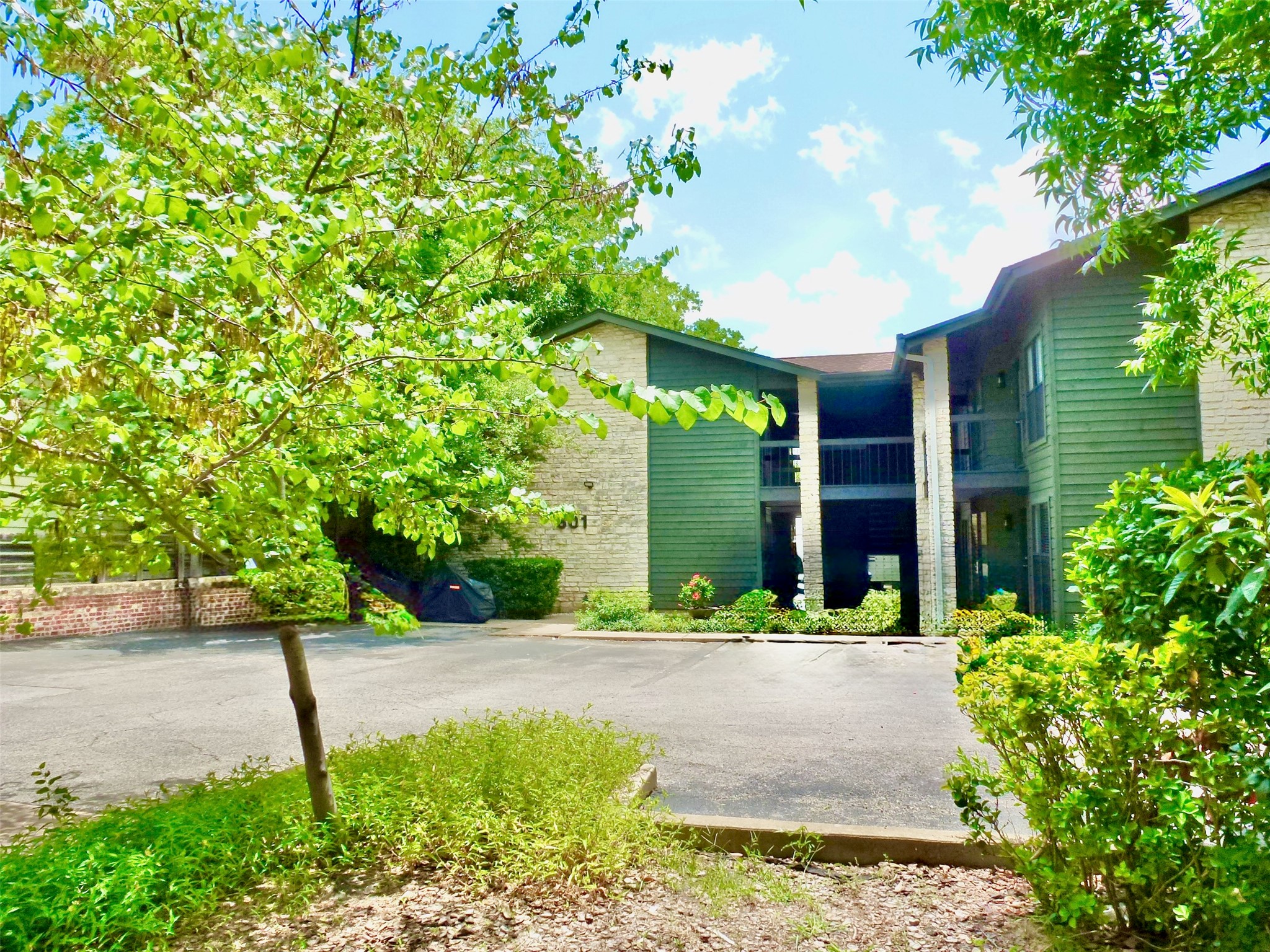 601 Hearn Street, Unit 207 Austin, TX 78703 - Photo 1 of 40 a front view of a house with a yard and trees