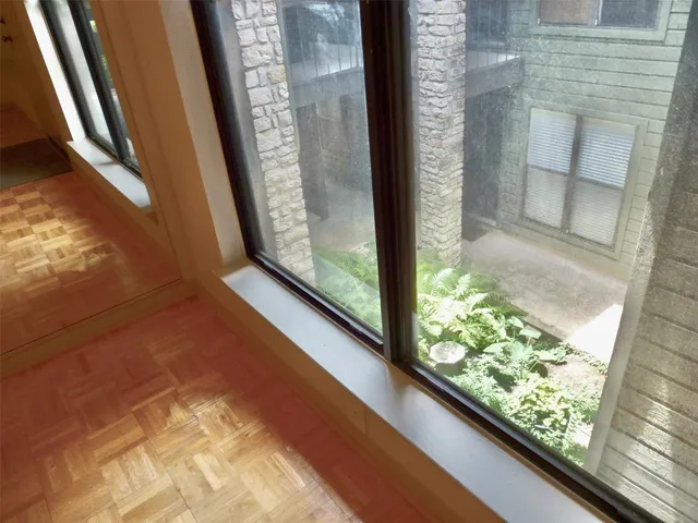 a front view of a house with potted plants