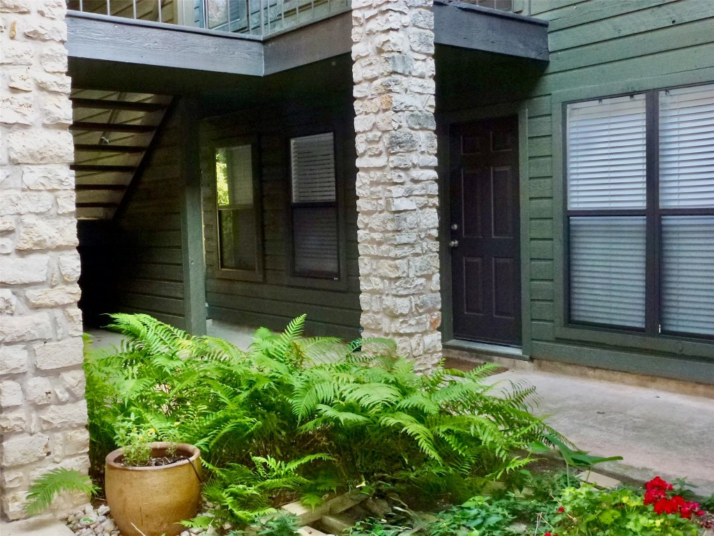 601 Hearn Street, Unit 207 Austin, TX 78703 - Photo 18 of 40 a front view of a house with potted plants