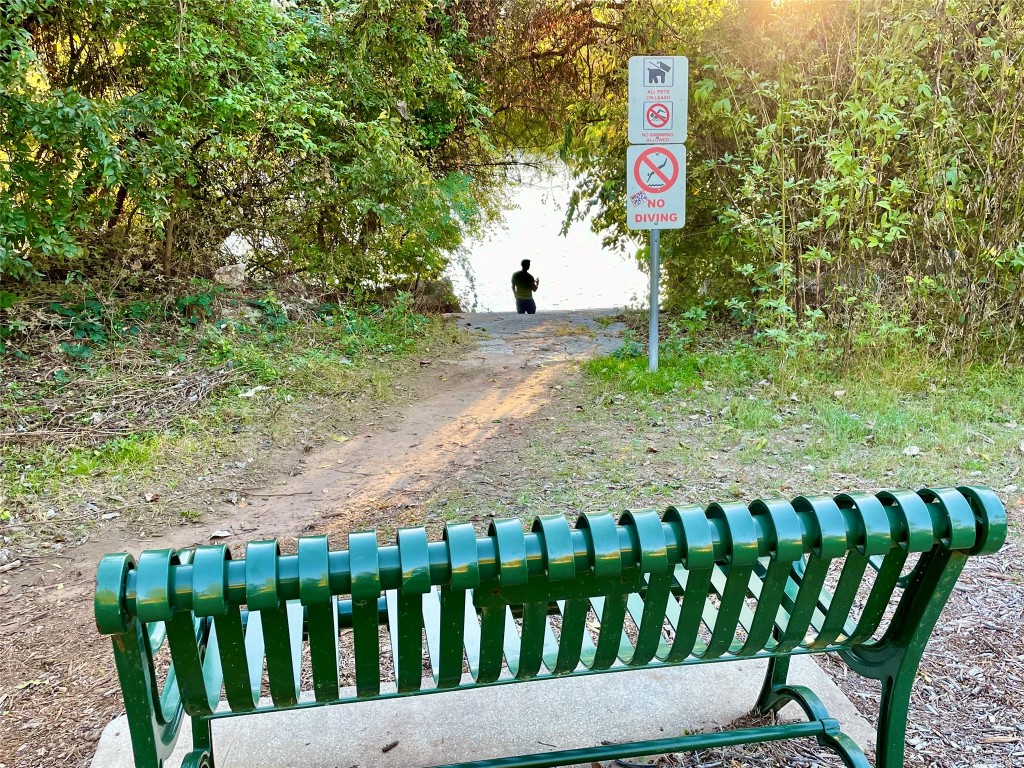 601 Hearn Street, Unit 207 Austin, TX 78703 - Photo 36 of 40 a street sign sitting on a wooden fence