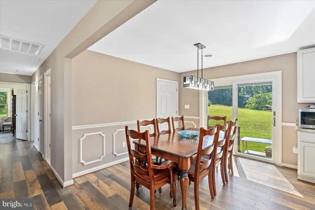 a view of kitchen with stainless steel appliances granite countertop a stove and a refrigerator