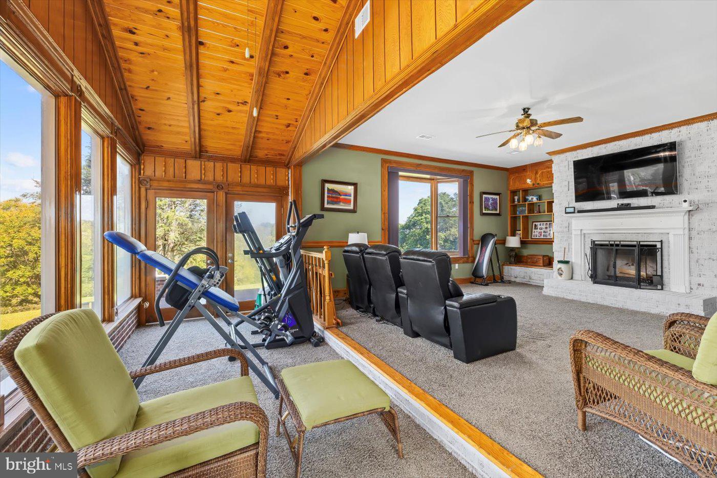 436 Castleton View Road Castleton, VA 22716 - Photo 24 of 66 a living room with furniture a flat screen tv and a floor to ceiling window