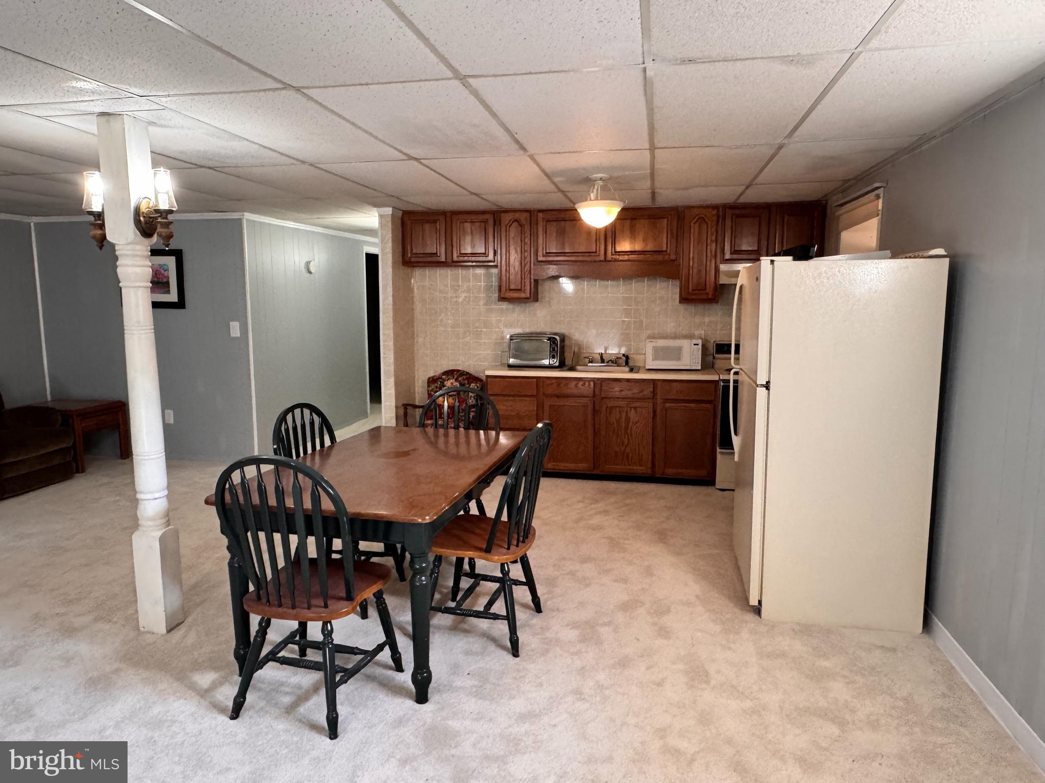 436 Castleton View Road Castleton, VA 22716 - Photo 34 of 66 a kitchen with stainless steel appliances a refrigerator a stove a sink dishwasher with a dining table and chairs