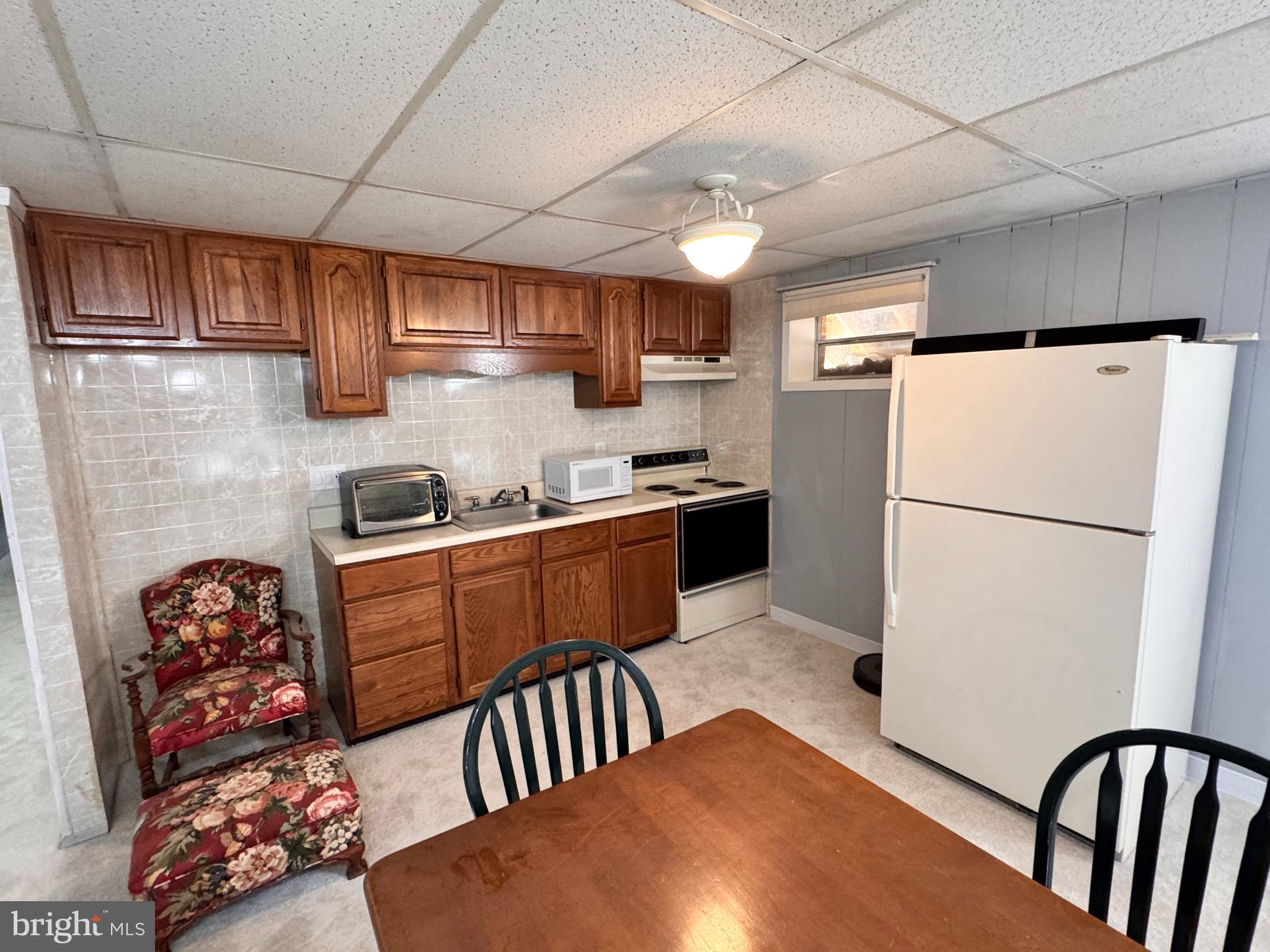 436 Castleton View Road Castleton, VA 22716 - Photo 35 of 66 a kitchen with stainless steel appliances granite countertop a refrigerator stove a sink dishwasher and white cabinets with wooden floor