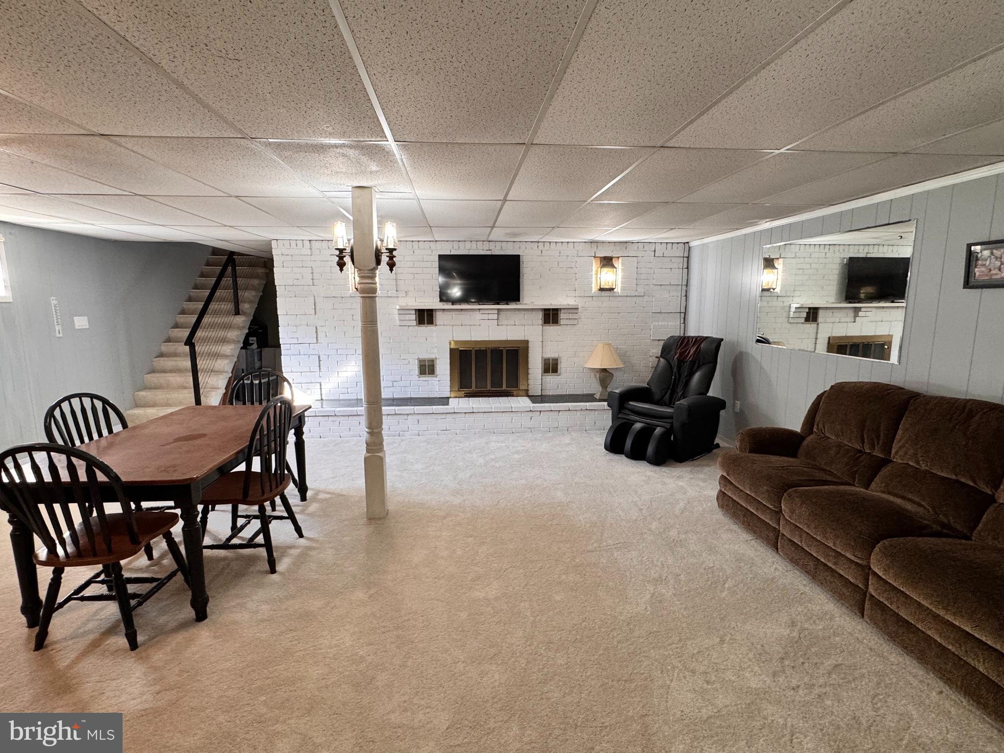 436 Castleton View Road Castleton, VA 22716 - Photo 37 of 66 a living room with furniture a flat screen tv and a fireplace