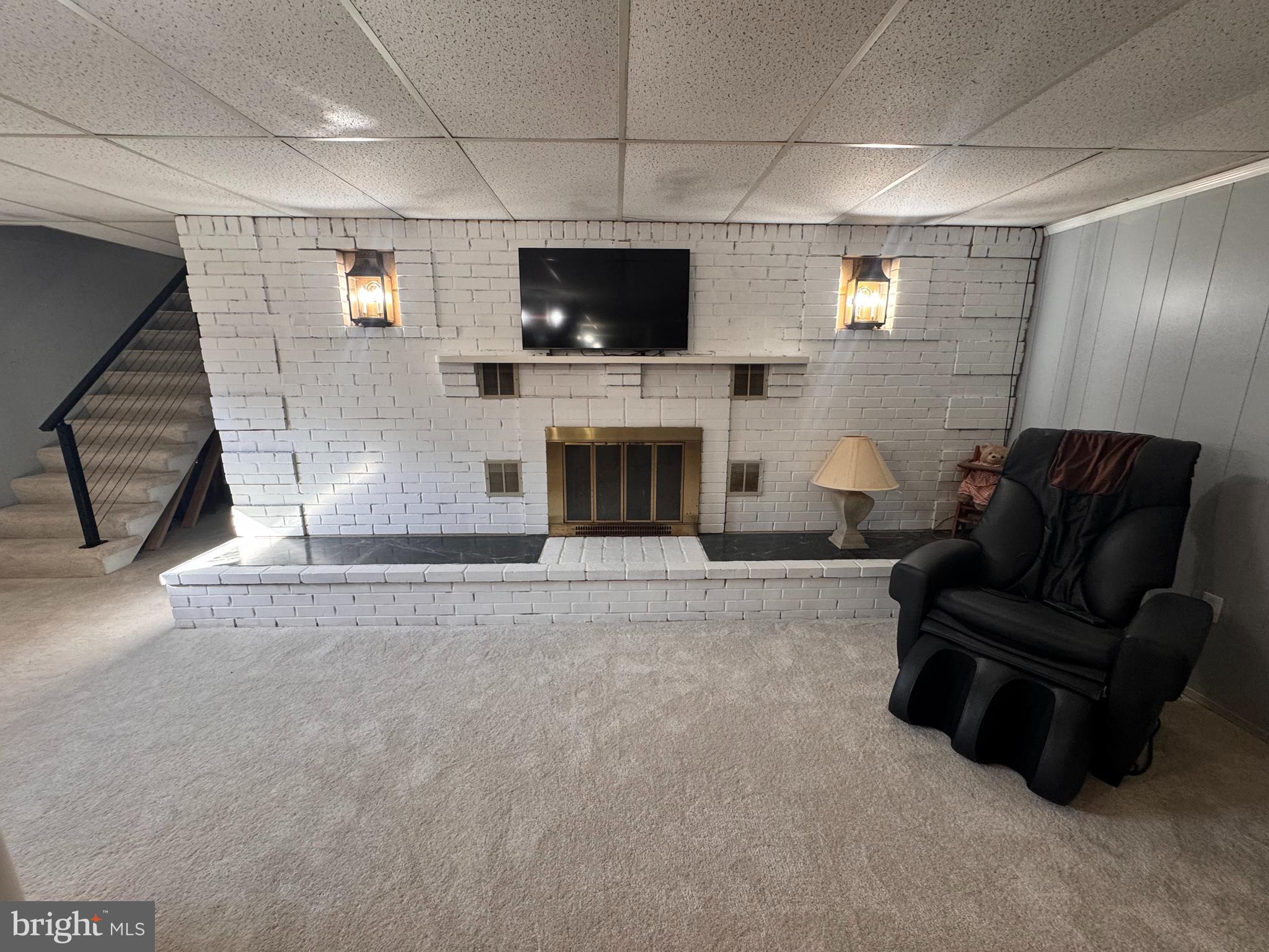 436 Castleton View Road Castleton, VA 22716 - Photo 40 of 66 a living room with furniture a fireplace and a flat screen tv