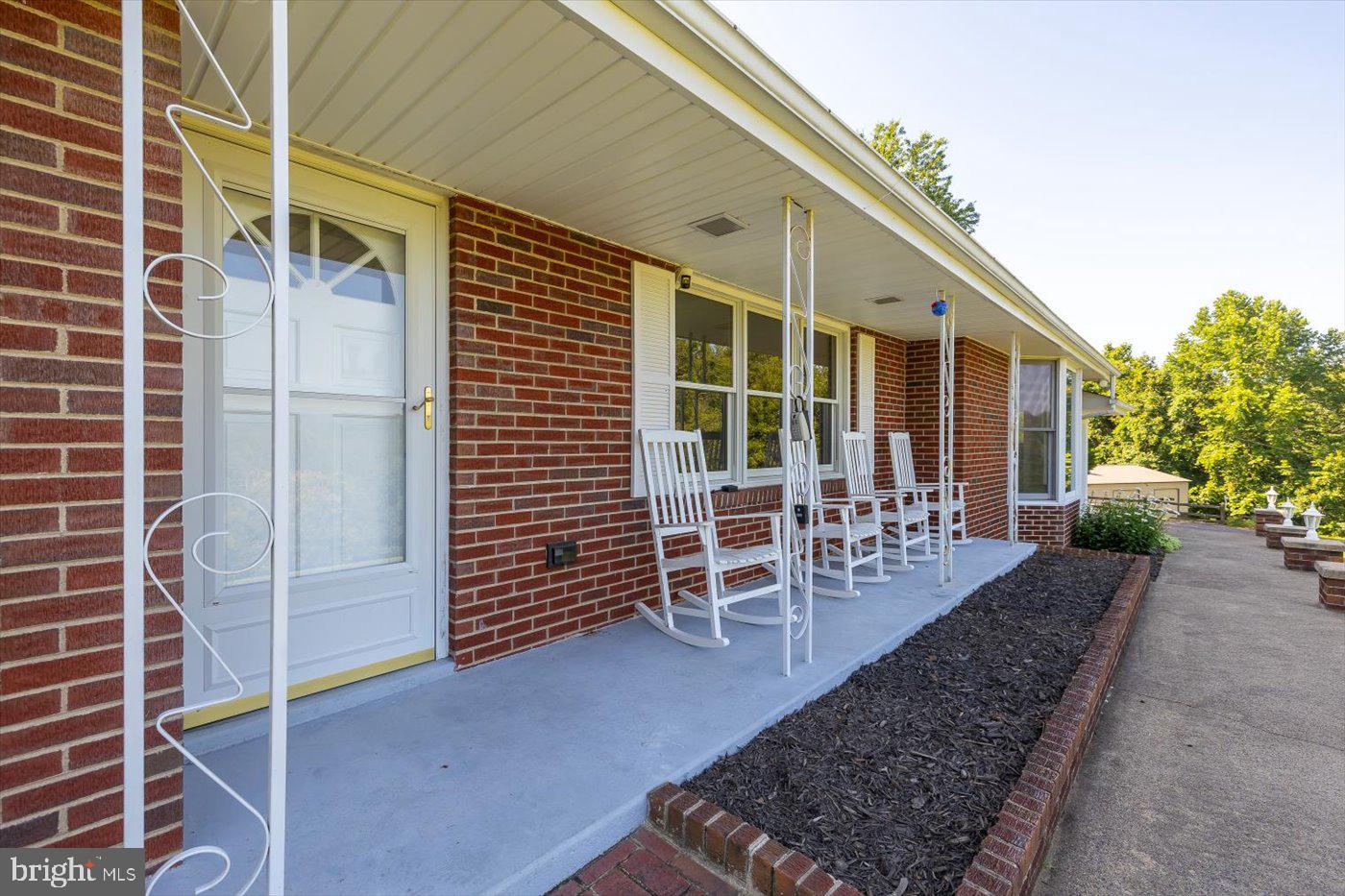 436 Castleton View Road Castleton, VA 22716 - Photo 47 of 66 a view of a patio with table and chairs and potted plants
