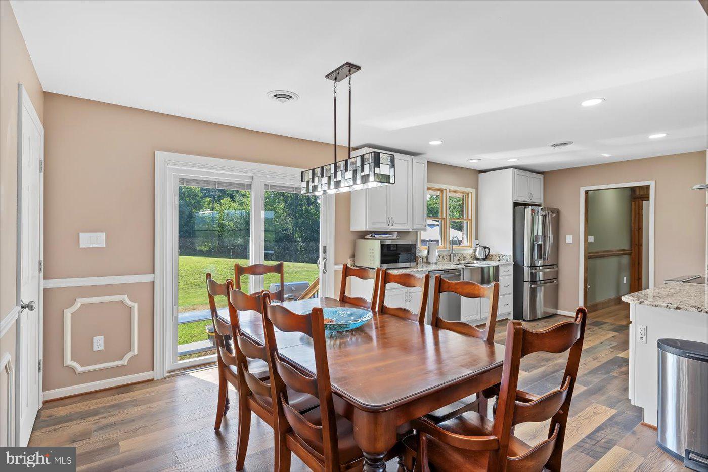 436 Castleton View Road Castleton, VA 22716 - Photo 9 of 66 a dining room with furniture a chandelier and wooden floor