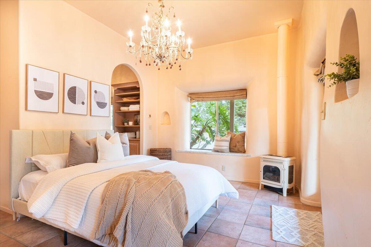 1910 Tularosa Road Lompoc, CA 93436 - Photo 12 of 55 a spacious bedroom with a bed and a chandelier