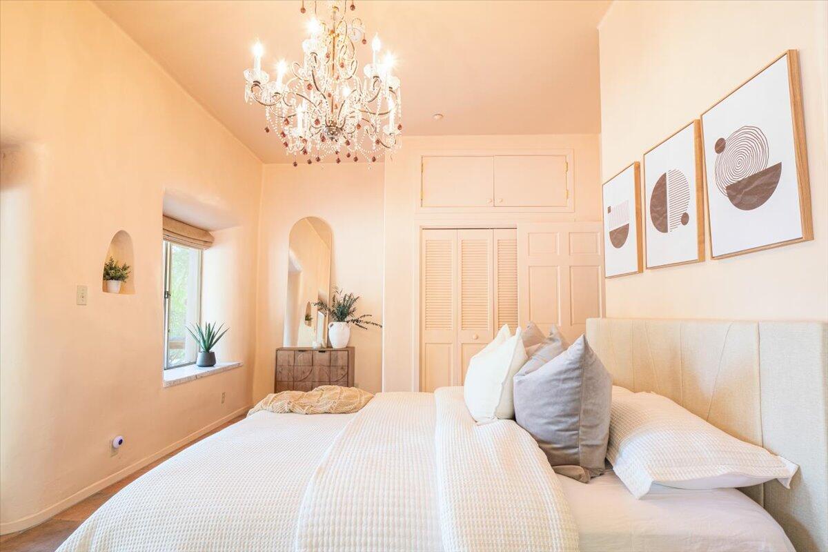 1910 Tularosa Road Lompoc, CA 93436 - Photo 17 of 55 a bedroom with a bed and a chandelier