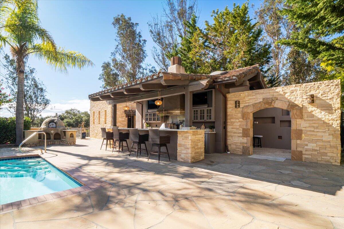 1910 Tularosa Road Lompoc, CA 93436 - Photo 2 of 55 a patio with a table and chairs under an umbrella