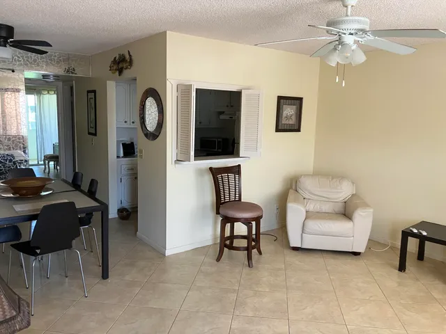 a living room with furniture and a mirror