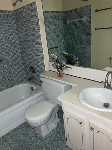 a bathroom with a sink a toilet and bathtub