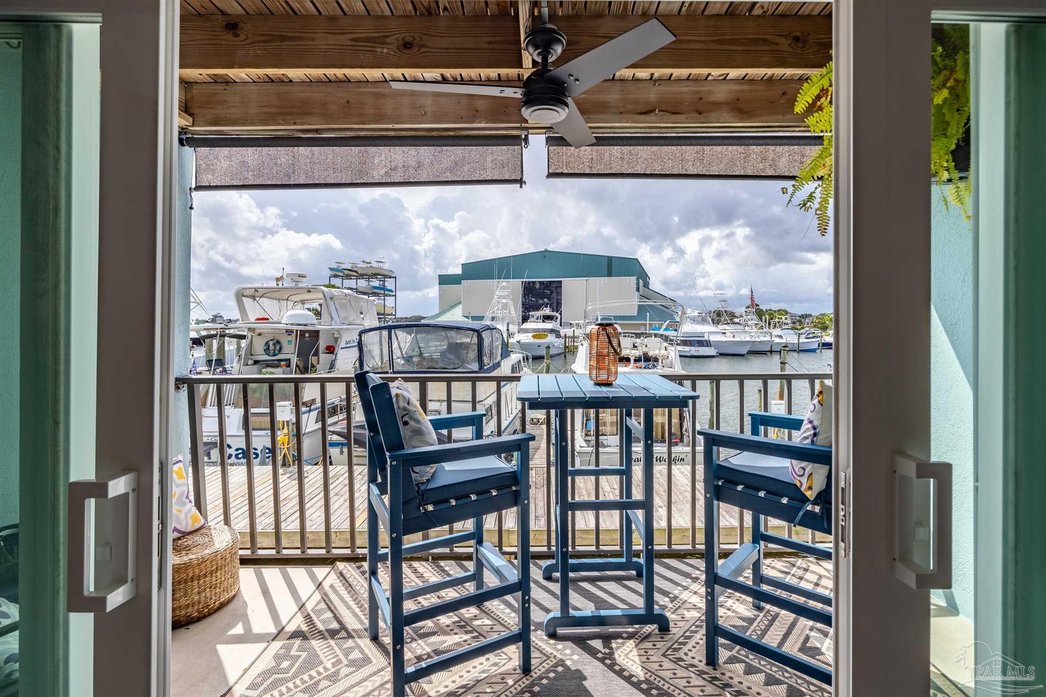 14100 River Road, Unit 122B Perdido Key, FL 32507 - Photo 17 of 46 a view of a balcony with a dining table and chairs
