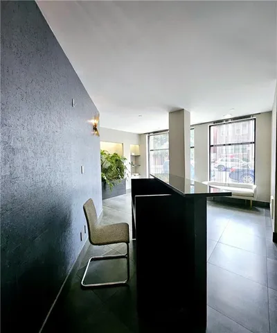 a view of a room with furniture and windows