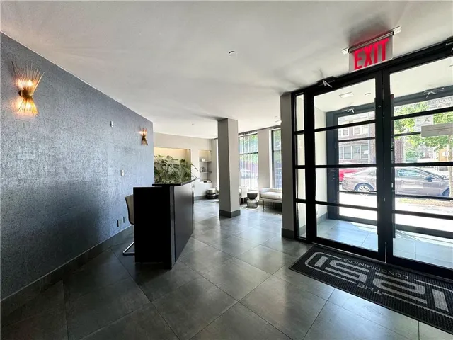 a view of a livingroom with furniture and floor to ceiling window