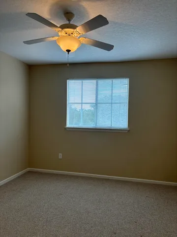 an empty room with wooden floor and a window