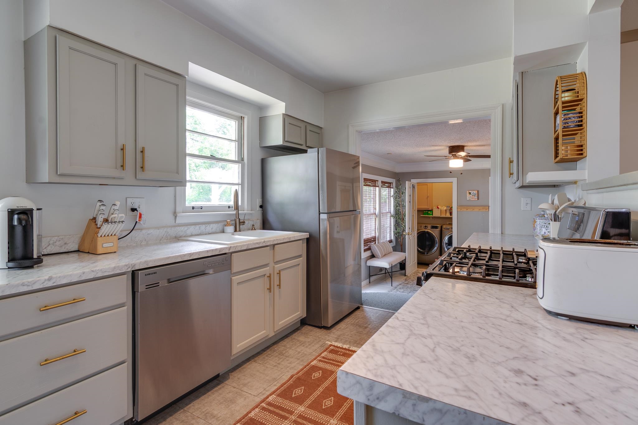4952 Mockingbird Lane Memphis, TN 38117 - Photo 13 of 28 a kitchen with granite countertop a sink stove and refrigerator