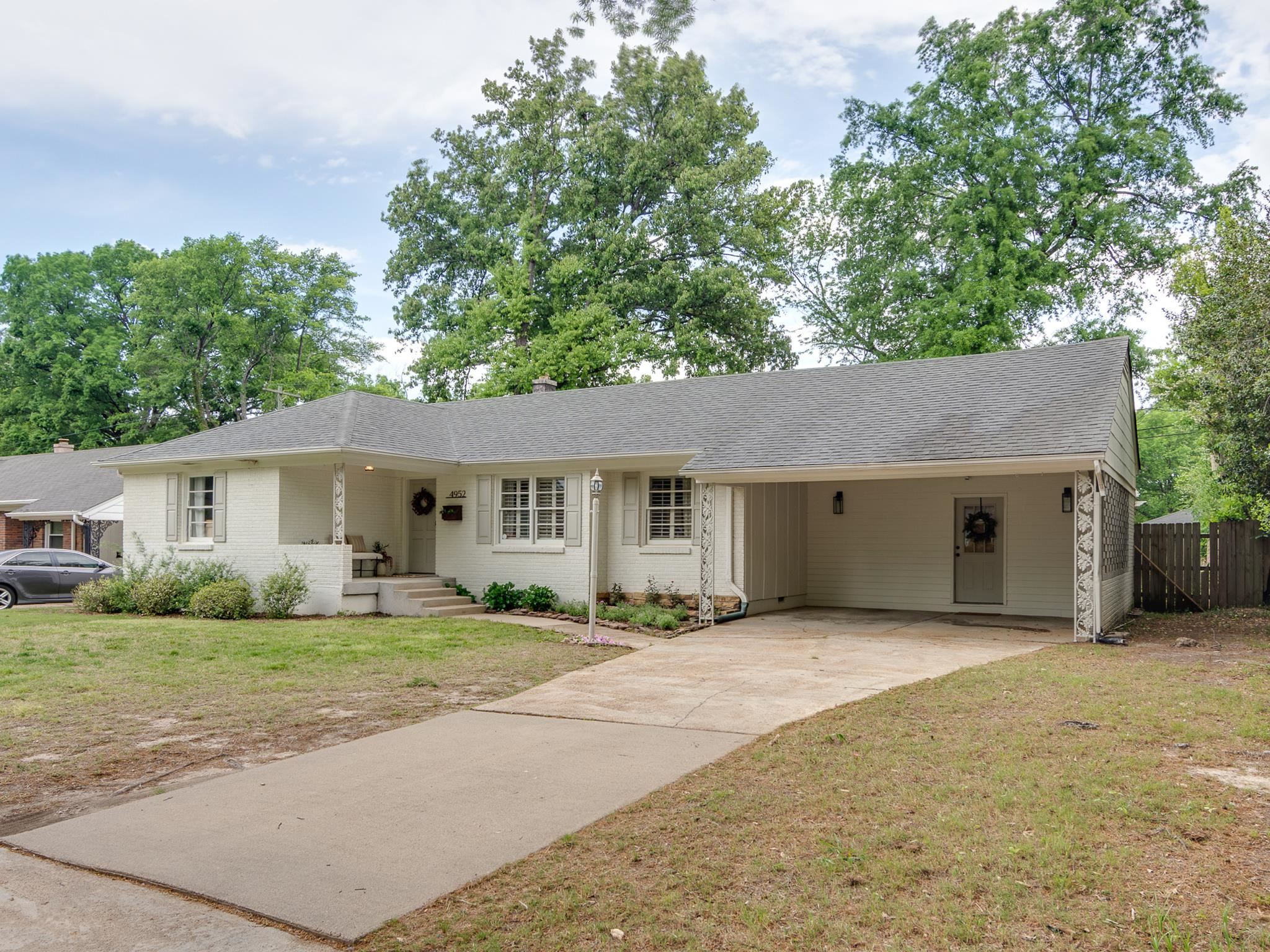 4952 Mockingbird Lane Memphis, TN 38117 - Photo 3 of 28 a house that has a tree in front of it