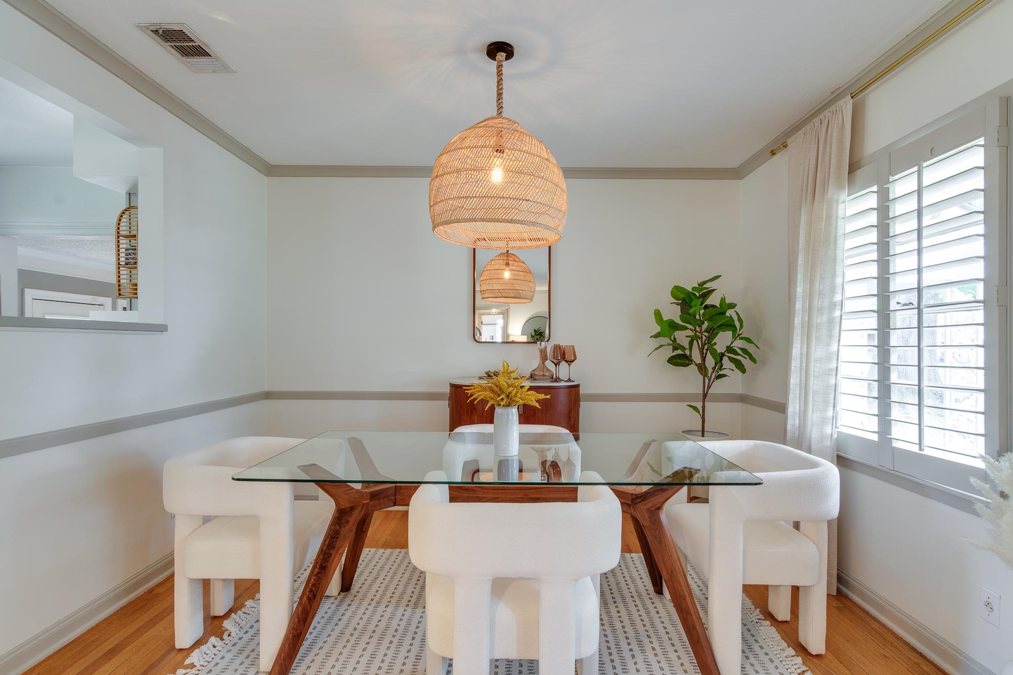 4952 Mockingbird Lane Memphis, TN 38117 - Photo 10 of 28 a dining room with furniture a potted plant and wooden floor