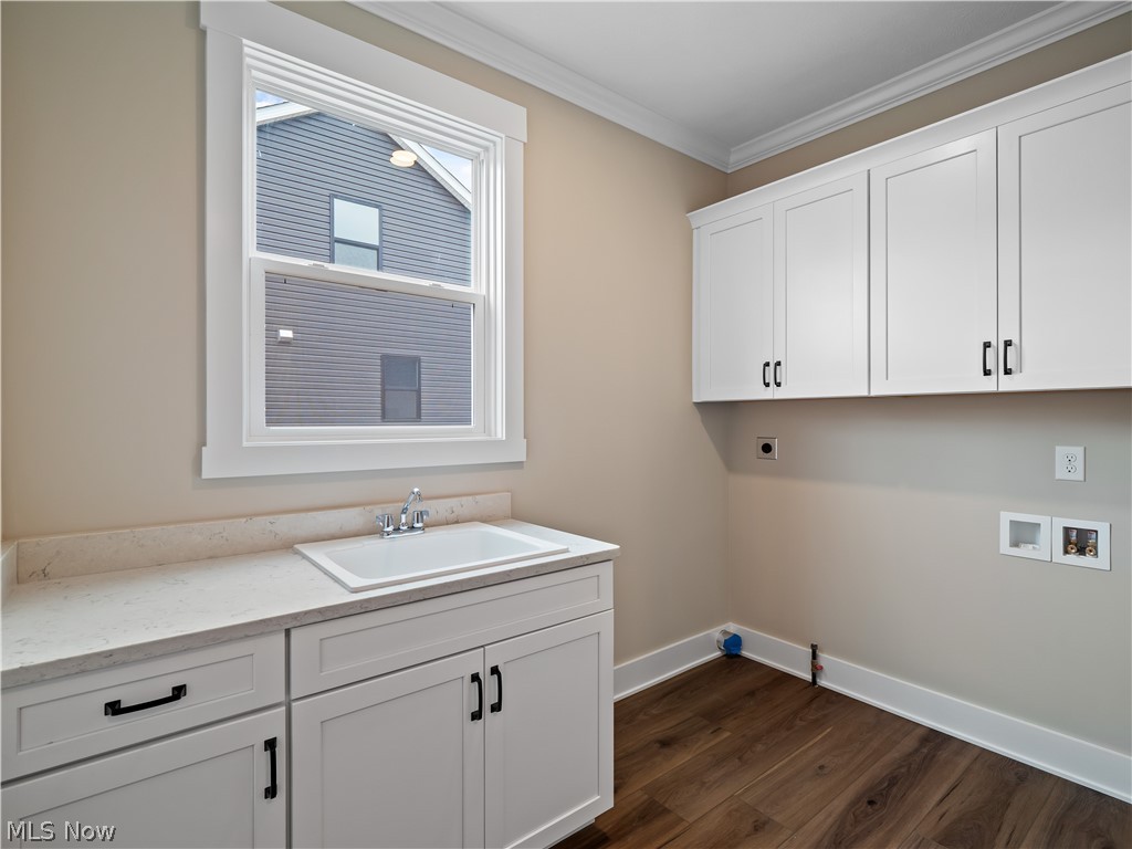 34270 Brookside Lane North Ridgeville, OH 44039 - Photo 23 of 50 Laundry room with ornamental molding, cabinet space, dark wood-style floors, electric dryer hookup, and washer hookup