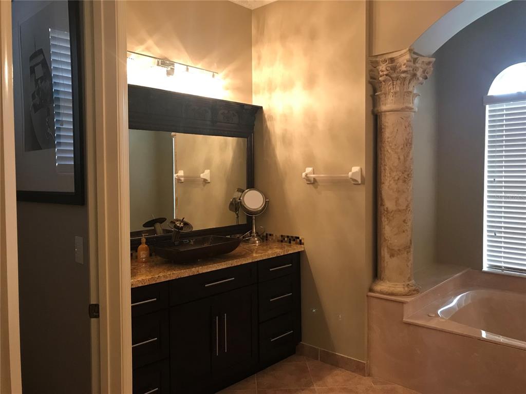 9543 Campi Drive Lake Worth, FL 33467 - Photo 14 of 23 a bathroom with a granite countertop sink and a mirror