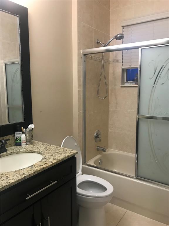 9543 Campi Drive Lake Worth, FL 33467 - Photo 17 of 23 a bathroom with a granite countertop sink toilet and shower