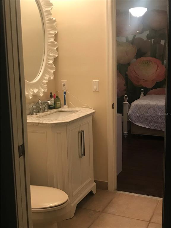 9543 Campi Drive Lake Worth, FL 33467 - Photo 18 of 23 a bathroom with a granite countertop sink and a mirror