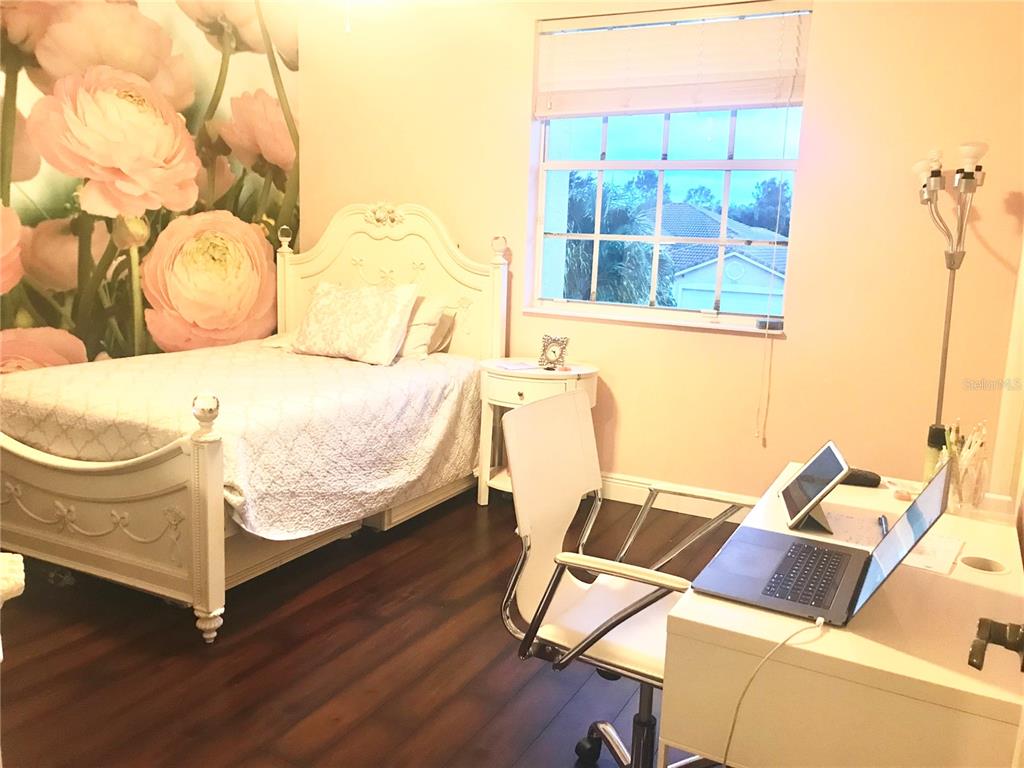 9543 Campi Drive Lake Worth, FL 33467 - Photo 20 of 23 a bedroom with a bed and wooden floor