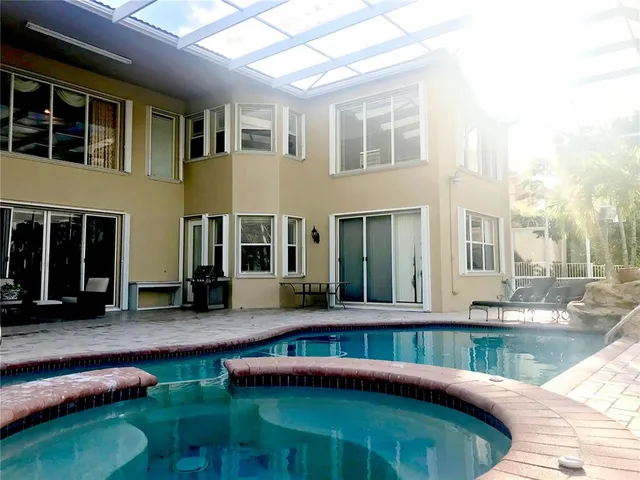 a view of a backyard with swimming pool