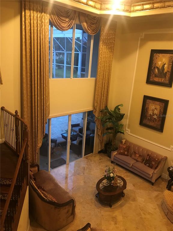 9543 Campi Drive Lake Worth, FL 33467 - Photo 5 of 23 a living room with furniture and a potted plant