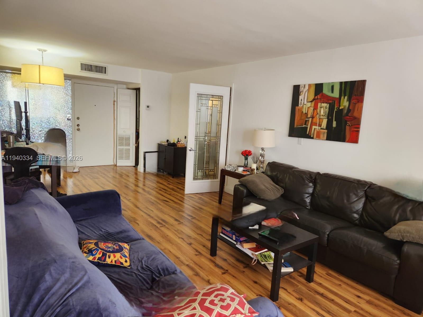 290 174th Street, Unit 1908 Sunny Isles Beach, FL 33160 - Photo 21 of 29 a living room with furniture and wooden floor