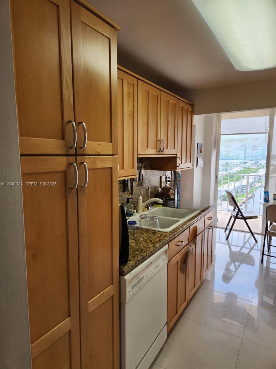 290 174th Street, Unit 1908 Sunny Isles Beach, FL 33160 - Photo 22 of 29 a kitchen with stainless steel appliances granite countertop a refrigerator a stove a sink and a window