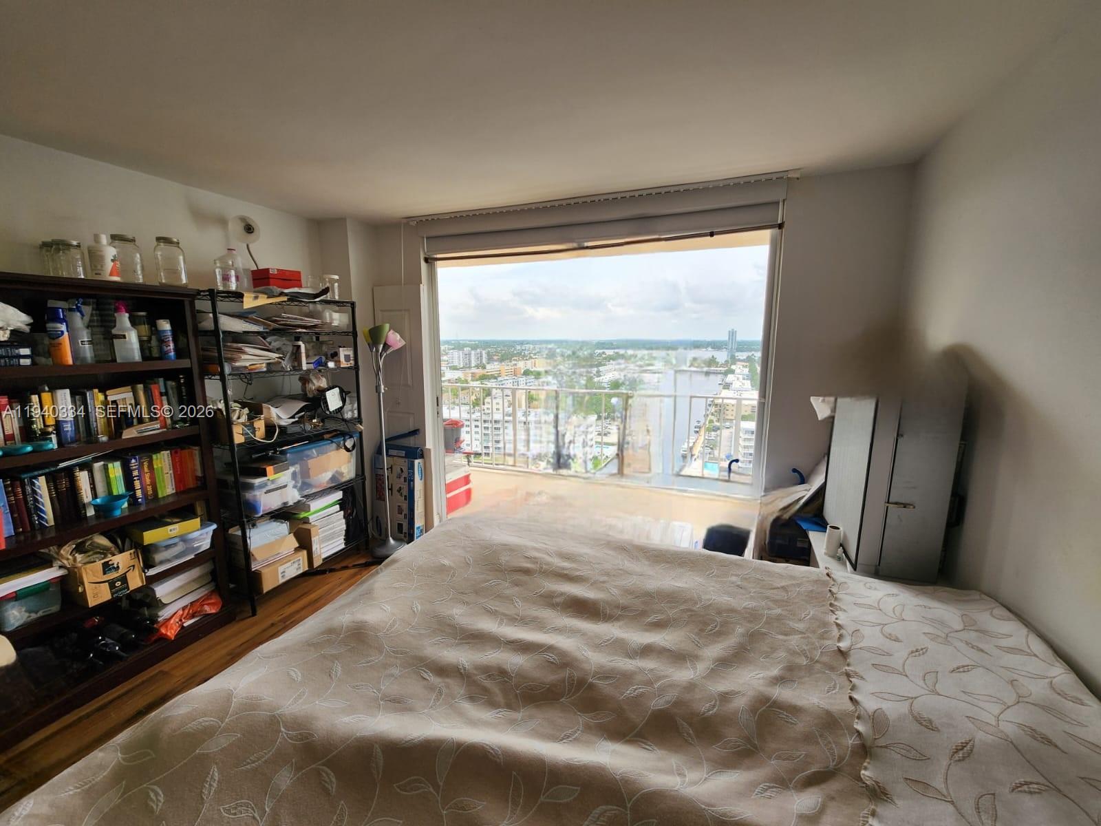 290 174th Street, Unit 1908 Sunny Isles Beach, FL 33160 - Photo 23 of 29 a large bed sitting in a bedroom next to a window