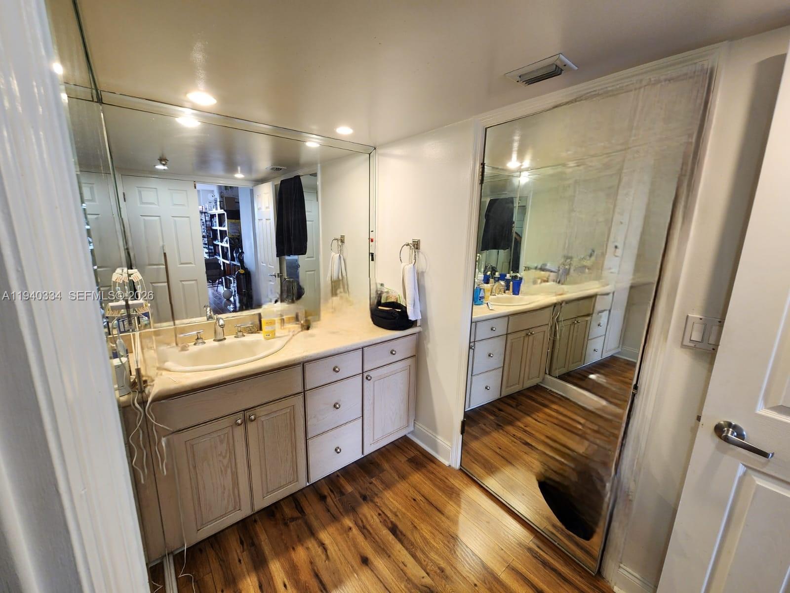 290 174th Street, Unit 1908 Sunny Isles Beach, FL 33160 - Photo 26 of 29 a bathroom with a double vanity sink and mirror with shower