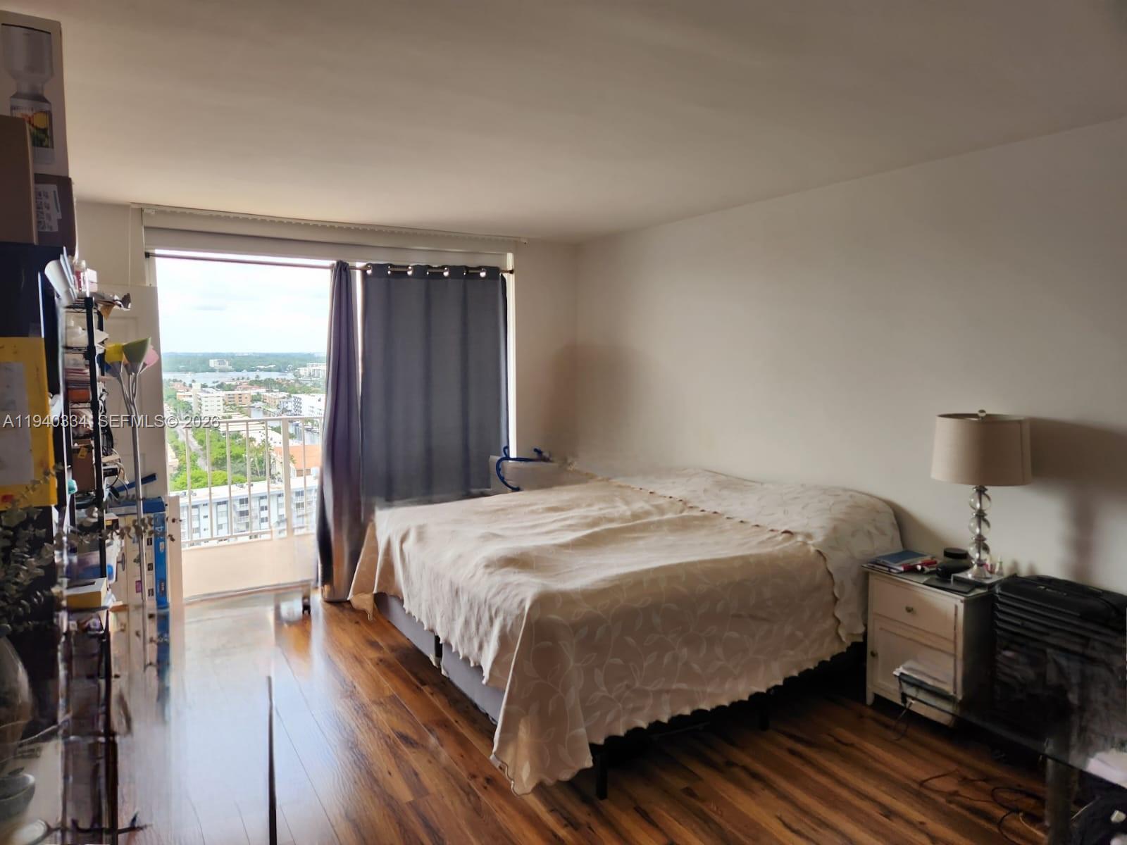 290 174th Street, Unit 1908 Sunny Isles Beach, FL 33160 - Photo 6 of 29 a bedroom with a bed and wooden floor