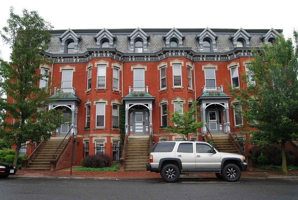 a front view of a residential apartment building with a yard