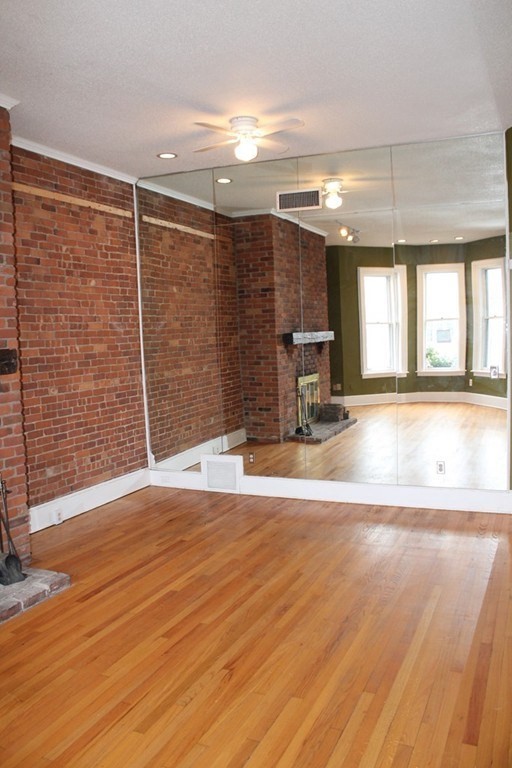 76 Temple Street, Unit 2 Springfield, MA 01105 - Photo 7 of 15 a view of an empty room with a fireplace and a window