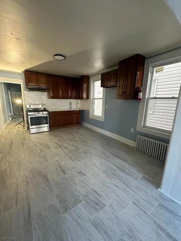 a view of kitchen with sink and cabinets