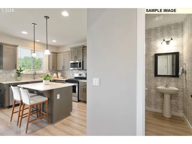 a kitchen with kitchen island a sink cabinets and wooden floor