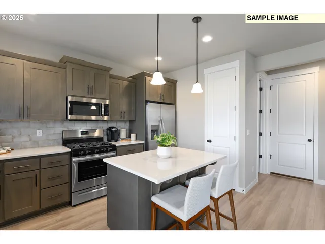 a kitchen with a sink a microwave a stove and refrigerator