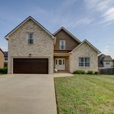 a front view of a house with yard