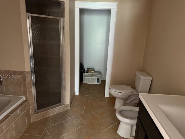 1020 Pine Top Road Toone, TN 38381 - Photo 12 of 16 Bathroom featuring a glass-enclosed shower, a corner built-in bathtub with tiled surround, and ceramic tile flooring