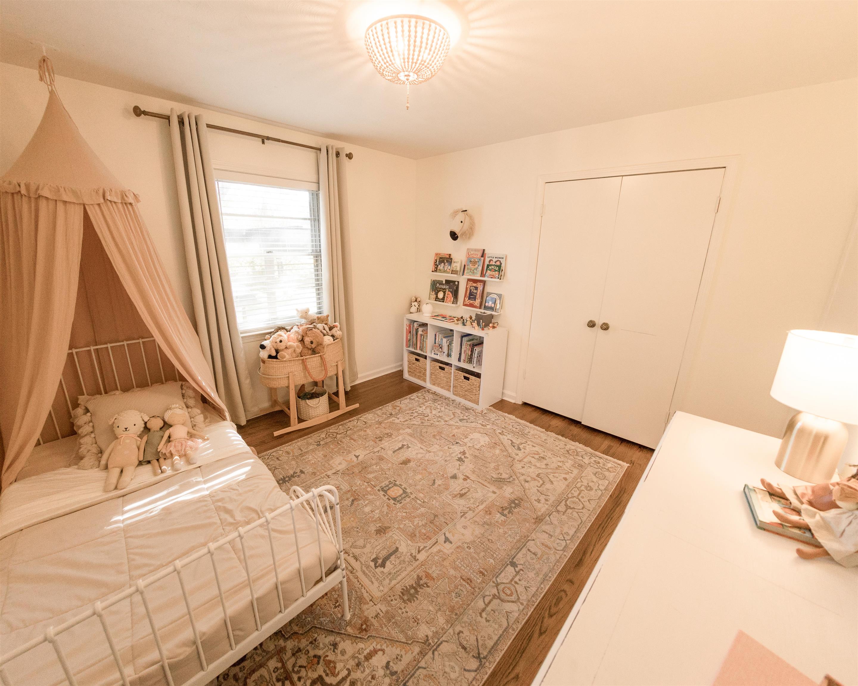 5431 Quince Road Memphis, TN 38119 - Photo 12 of 21 a bedroom with a bed and a flat tv screen on the dresser