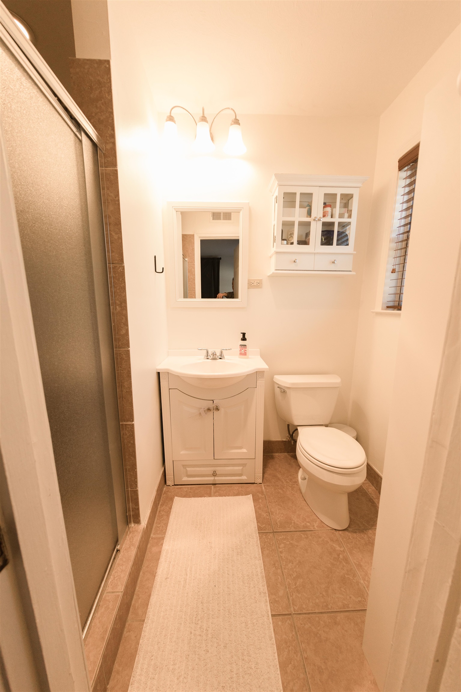 5431 Quince Road Memphis, TN 38119 - Photo 17 of 21 a bathroom with a sink a toilet a mirror and shower